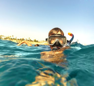 Boy floats in the sea clipart