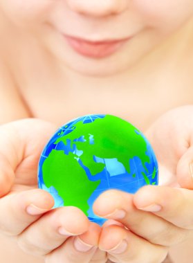 Boy holds globe in hands clipart