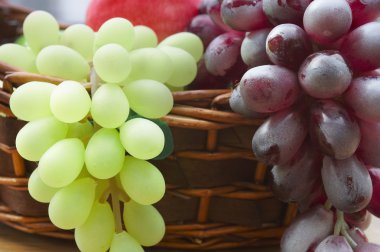 Red and white grape branch in a basket clipart