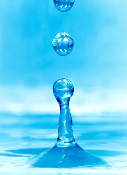 Falling drop of blue water — Stock Photo, Image