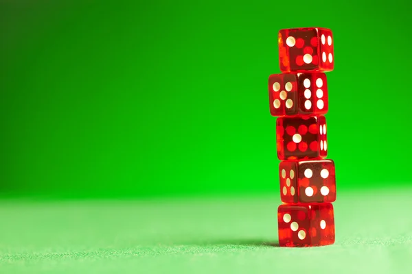 Red dices on green cloth — Stock Photo, Image