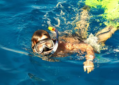 Boy floats in the sea clipart