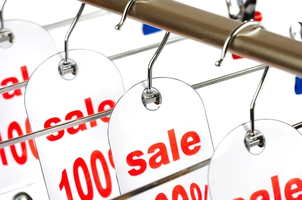 Sale. A hanger with labels on a white ba — Stock Photo, Image