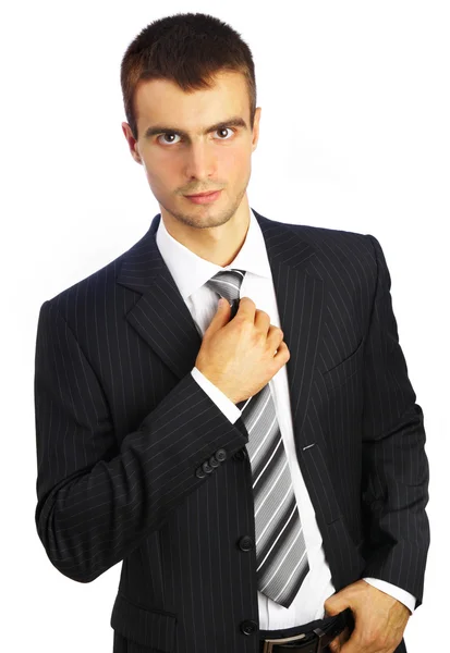 Νεαρός άνδρας σε ένα κοστούμι σε ένα λευκό αμουδερές — Φωτογραφία Αρχείου