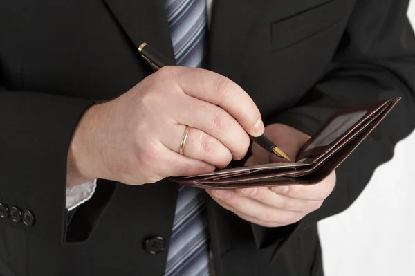 The businessman in a black suit signs a — Stock Photo, Image