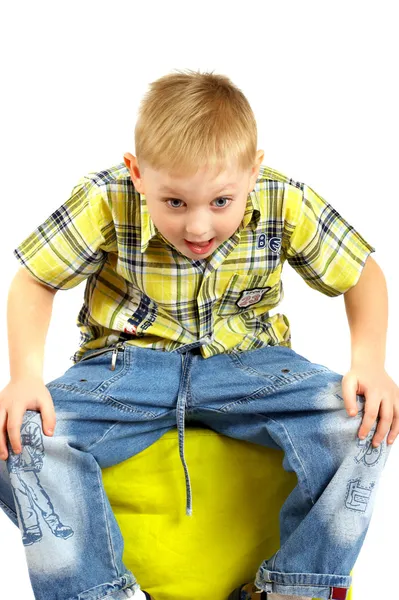 The boy the blonde sits on a stool. — Stock Photo, Image