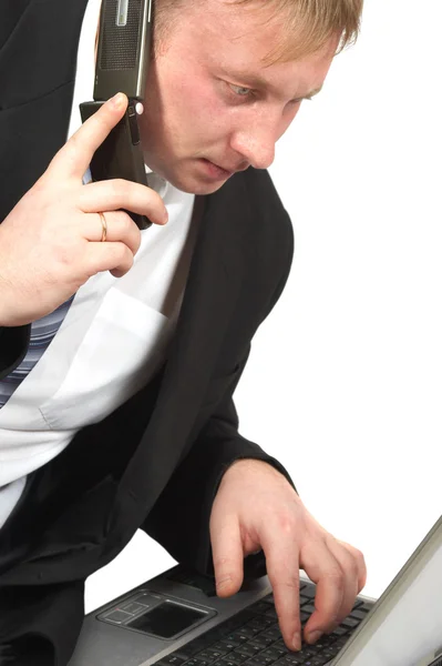 O homem de negócios com telefone e computador portátil — Fotografia de Stock