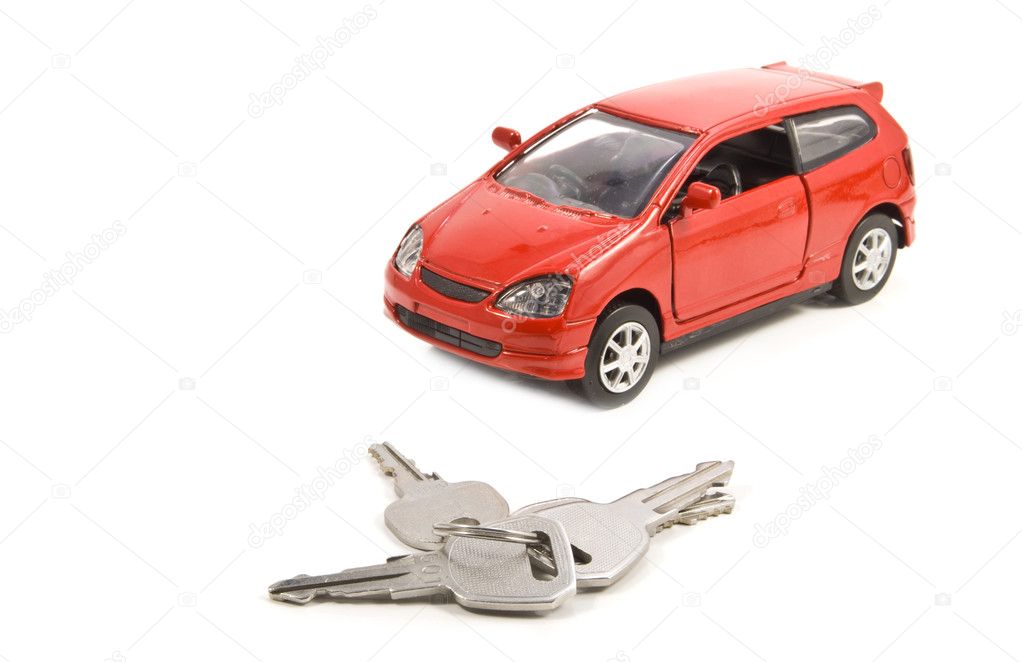 Keys and car isolated on white