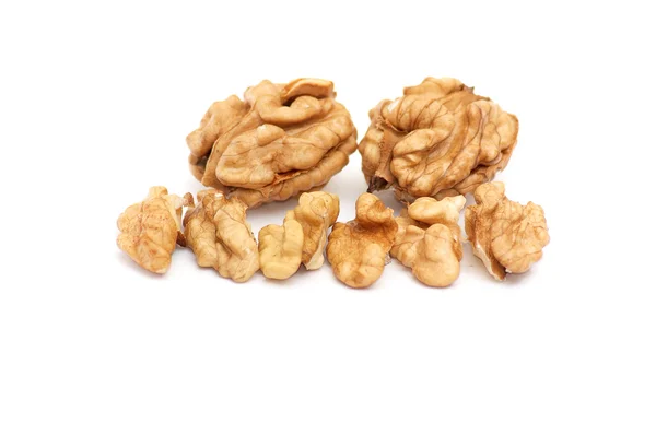 Pieces of walnuts on a white. — Stock Photo, Image