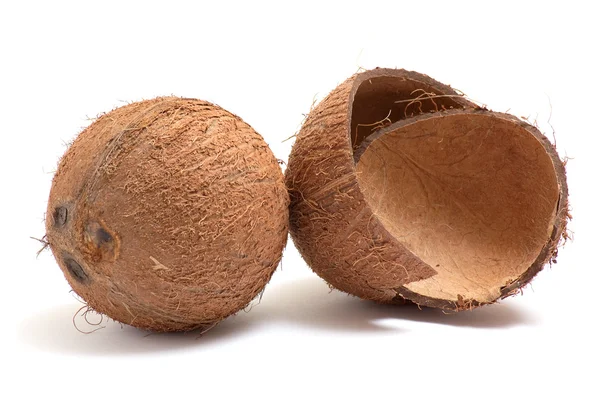 Hela och trasiga kokosnötter på en vit. — Stockfoto