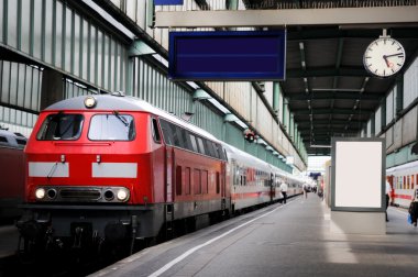 Train in the station with clock clipart
