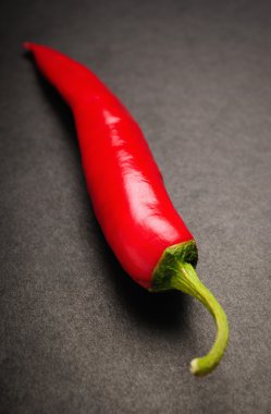 Chili pepper on black background clipart