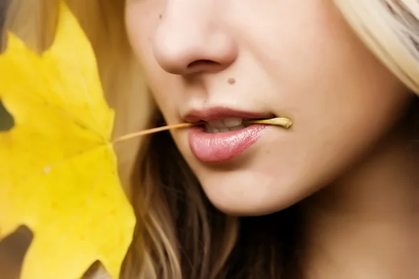 Dziewczyna z liść klonu w jej ustach — Zdjęcie stockowe