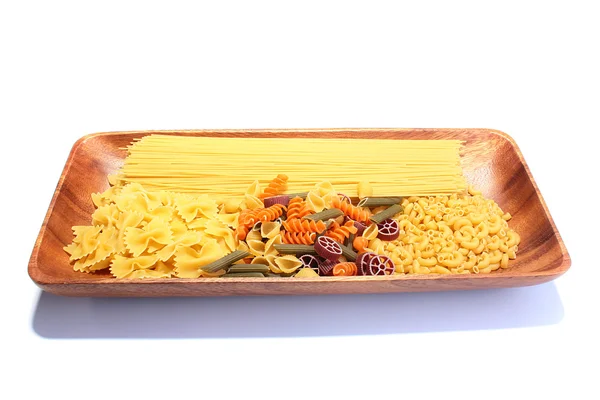 Wooden plate with macaroni — Stock Photo, Image