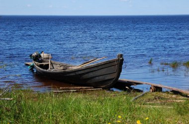 Old fishing wooden motor boat near the l clipart