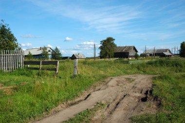 Ground road in northern russian village clipart