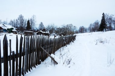 Snowy footpath near wooden fence clipart