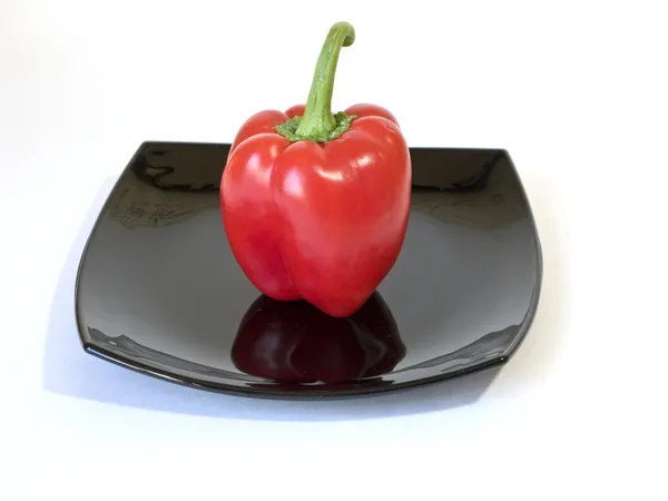 Κόκκινο πιπέρι στο πιάτο μαύρο — Φωτογραφία Αρχείου