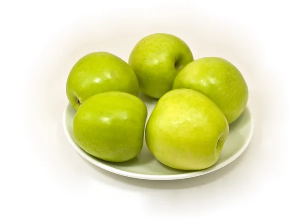 Zelená jablka v bílé desky — Stock fotografie