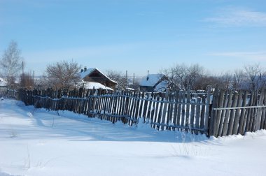 Wooden fence in winter village clipart