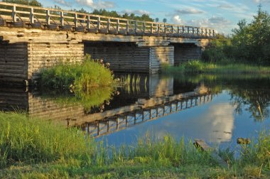 Old wooden bridge at sunset clipart