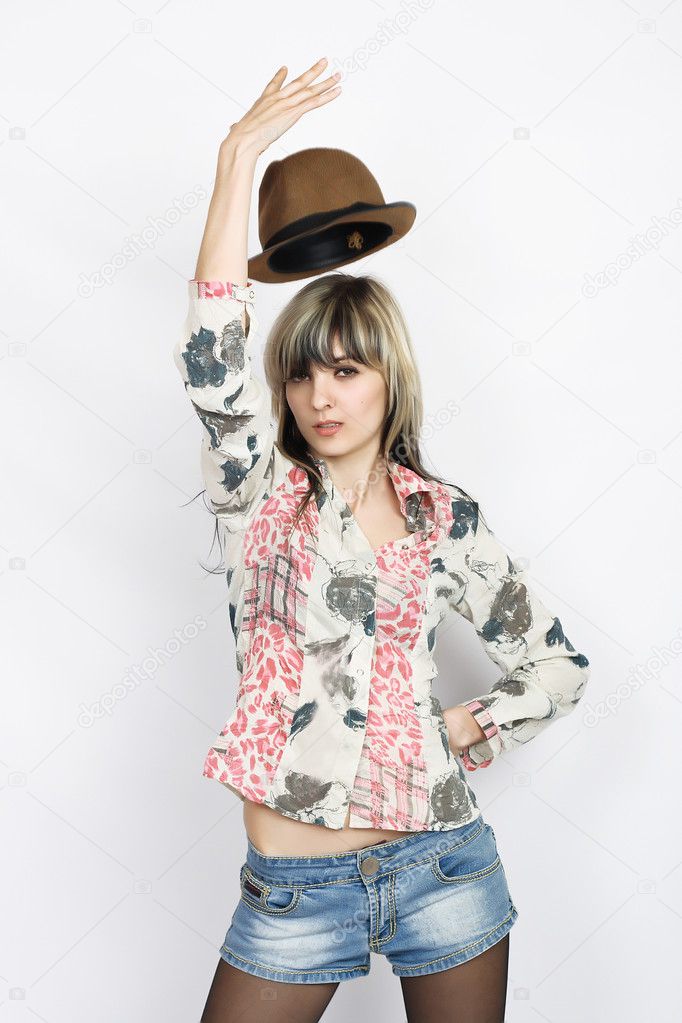 Beautiful young woman with hat posing