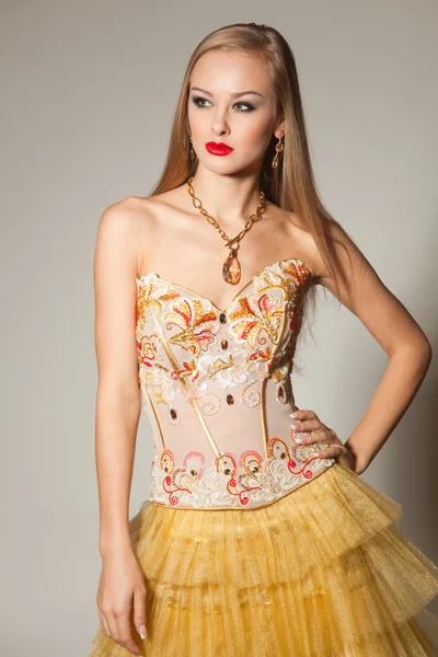 Elegant girl in gold dress — Stock Photo, Image