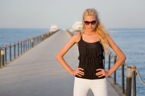 Model with bronze tan on a pier — Stock Photo, Image