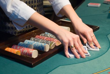 Croupier handling cards at poker table clipart