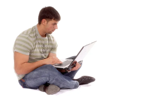 Junger Mann arbeitet mit Laptop lizenzfreie Stockfotos