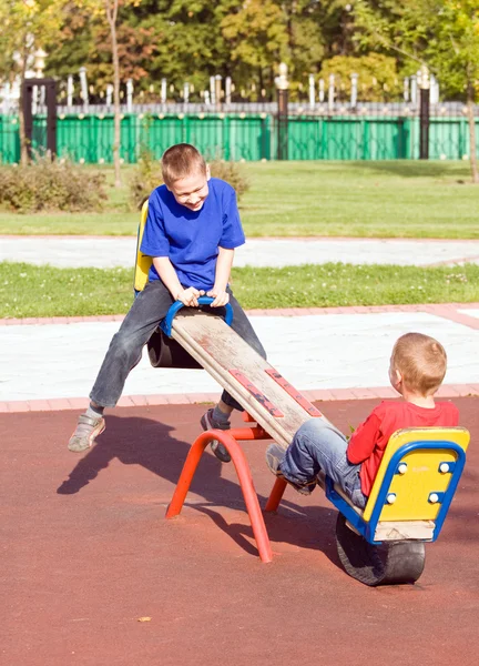 Children on a seesaw — Stock Photo, Image