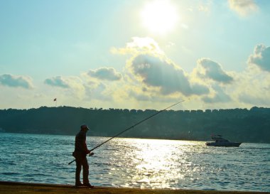 Fisherman at the sea clipart