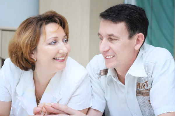 stock image Senior couple holding hands in bed