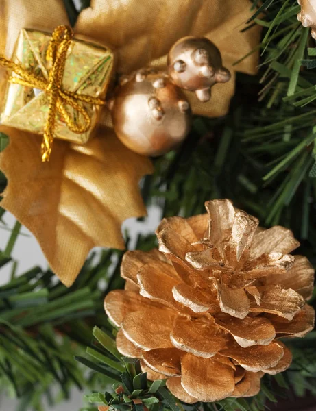 Golden pine cone on christmas tree — Stock Photo, Image