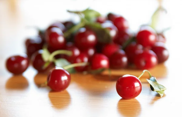 Red cherries on wooden table — Stock Photo, Image