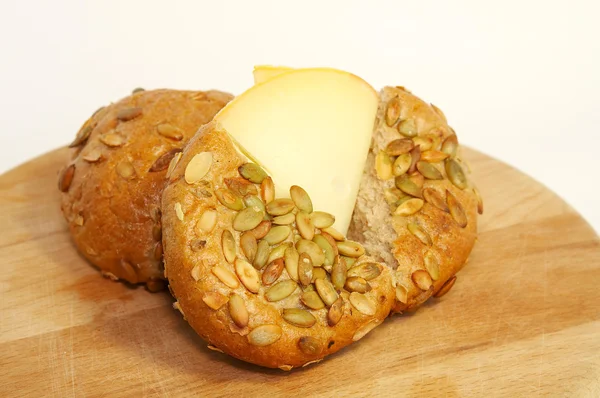 Cheese and bread with pumpkin seeds. — Stock Photo, Image