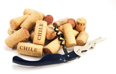 Corkscrew and several wine corks on whit clipart