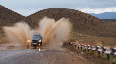 SUV on moutain road after rain. 2 clipart