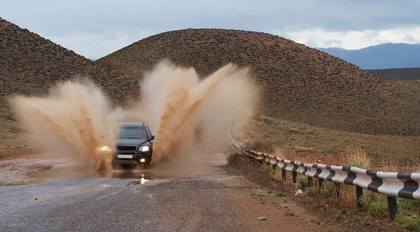 SUV on moutain road after rain. 2 — Stok fotoğraf