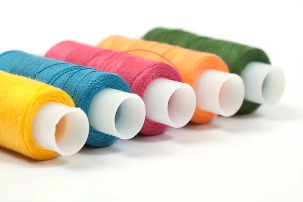 Color thread reels over white background — Stock Photo, Image