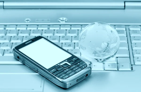 Cellular and glass globe on notebook — Stock Photo, Image