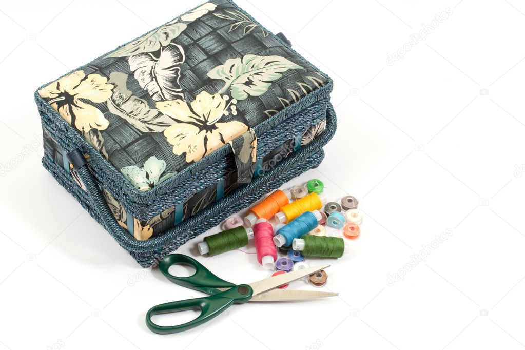 Blue box, sewing and scissors over white