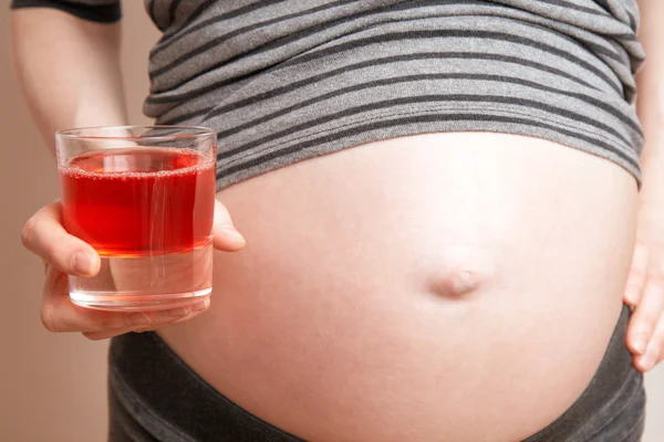 Pregnant woman with a juice — Stock Photo, Image
