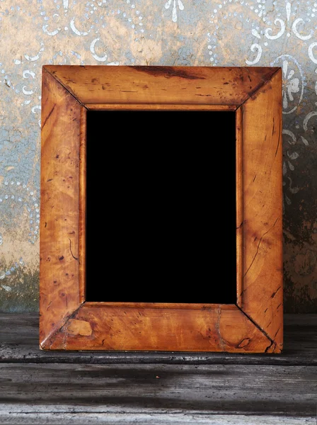 Old photo-frame on vintage table — Stock Photo, Image