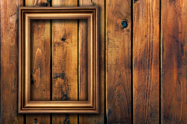 Moldura vazia na parede de madeira — Fotografia de Stock