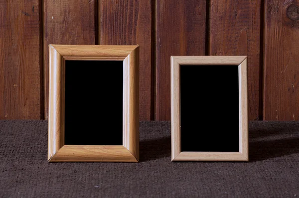 Photo frames on old table — Stock Photo, Image