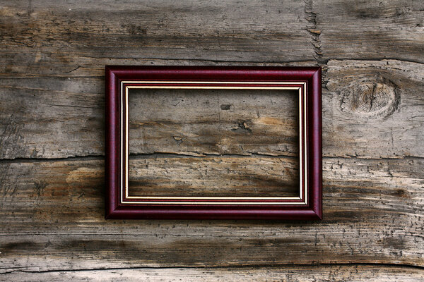 Blank frame on old wooden background