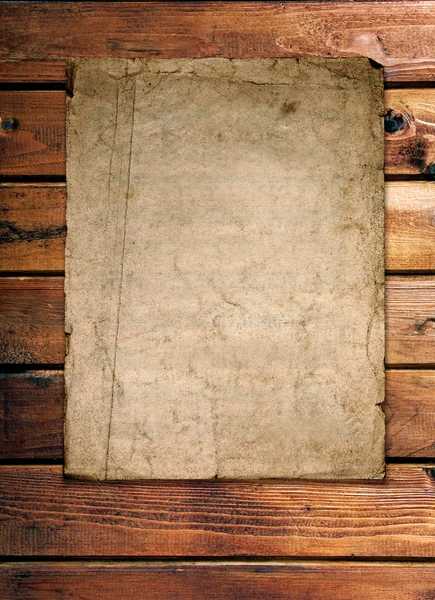Old paper on wood wall — Stock Photo, Image