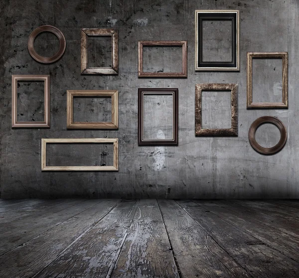 Grunge interior with frames — Stock Photo, Image