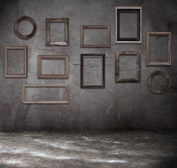 Grunge room with wooden frames — Stock Photo, Image